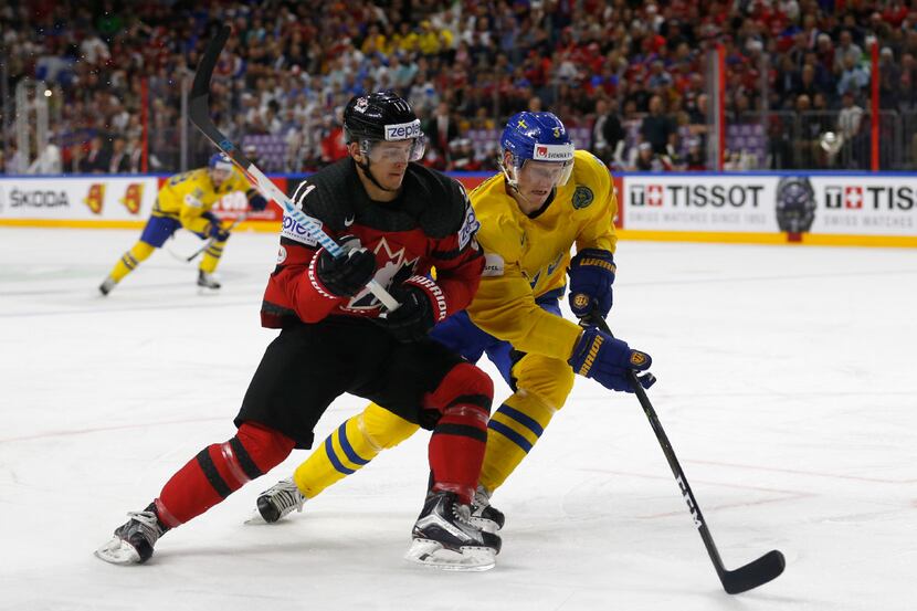 Canada's Travis Konecny (L) vies with Sweden's John Klingberg during the IIHF Men's World...