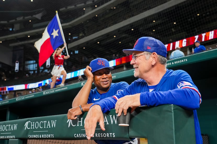 Texas Rangers manager Bruce Bochy (right) laughs with third base coach Tony Beasley before...