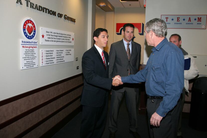 Rangers general manager Jon Daniels meets former US President George W. Bush at the Rangers...