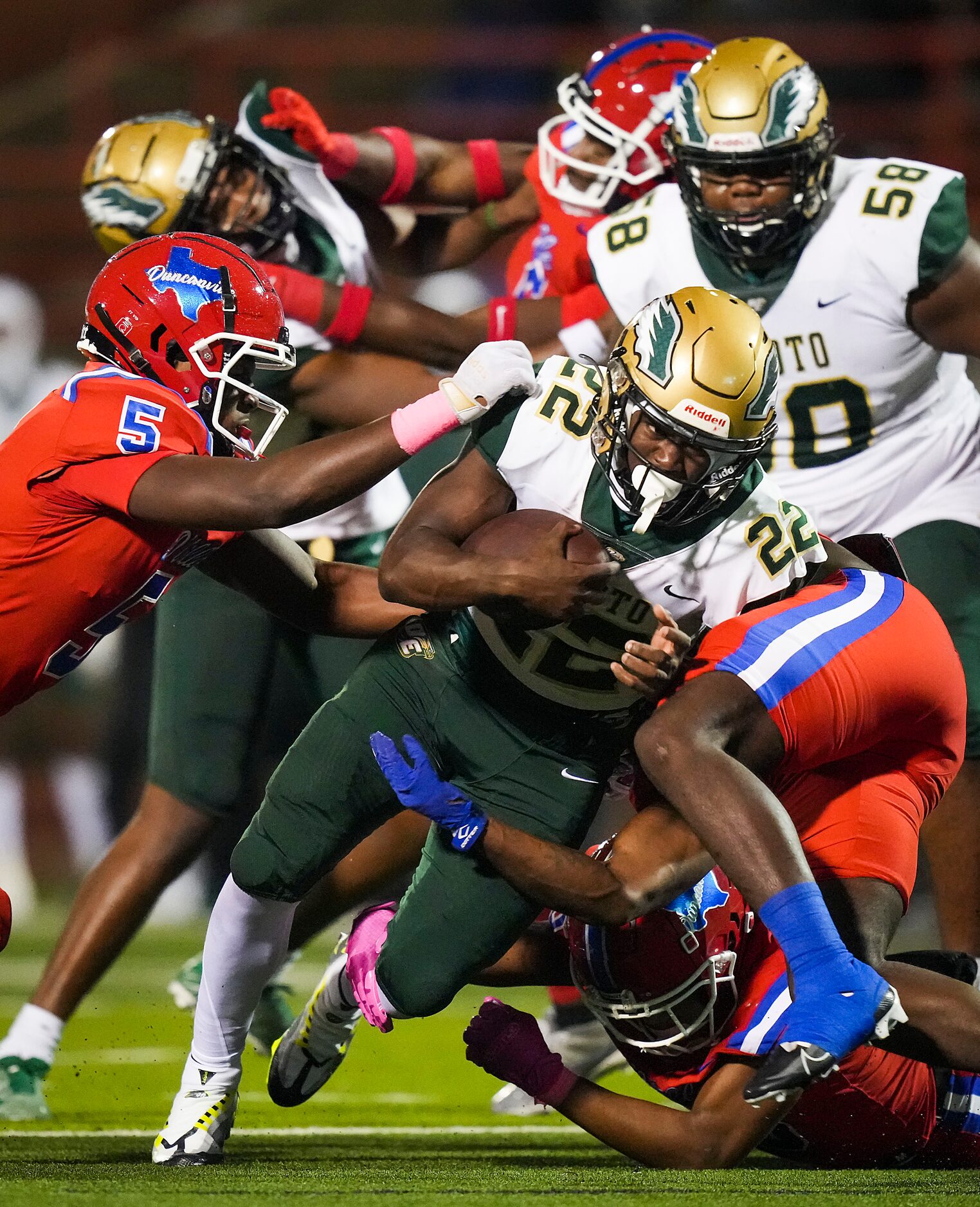 DeSoto running back Deondrae Riden Jr. (22) is brought down by Duncanville linebacker Eli...