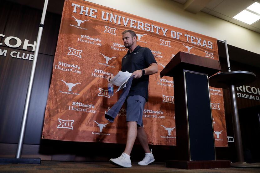Texas head coach Tom Herman departs an NCAA college football news conference, Thursday, Aug....