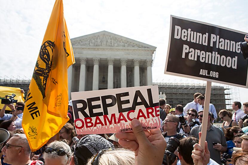 Conservatives rally against President Barack Obama's Affordable Care Act on Thursday outside...