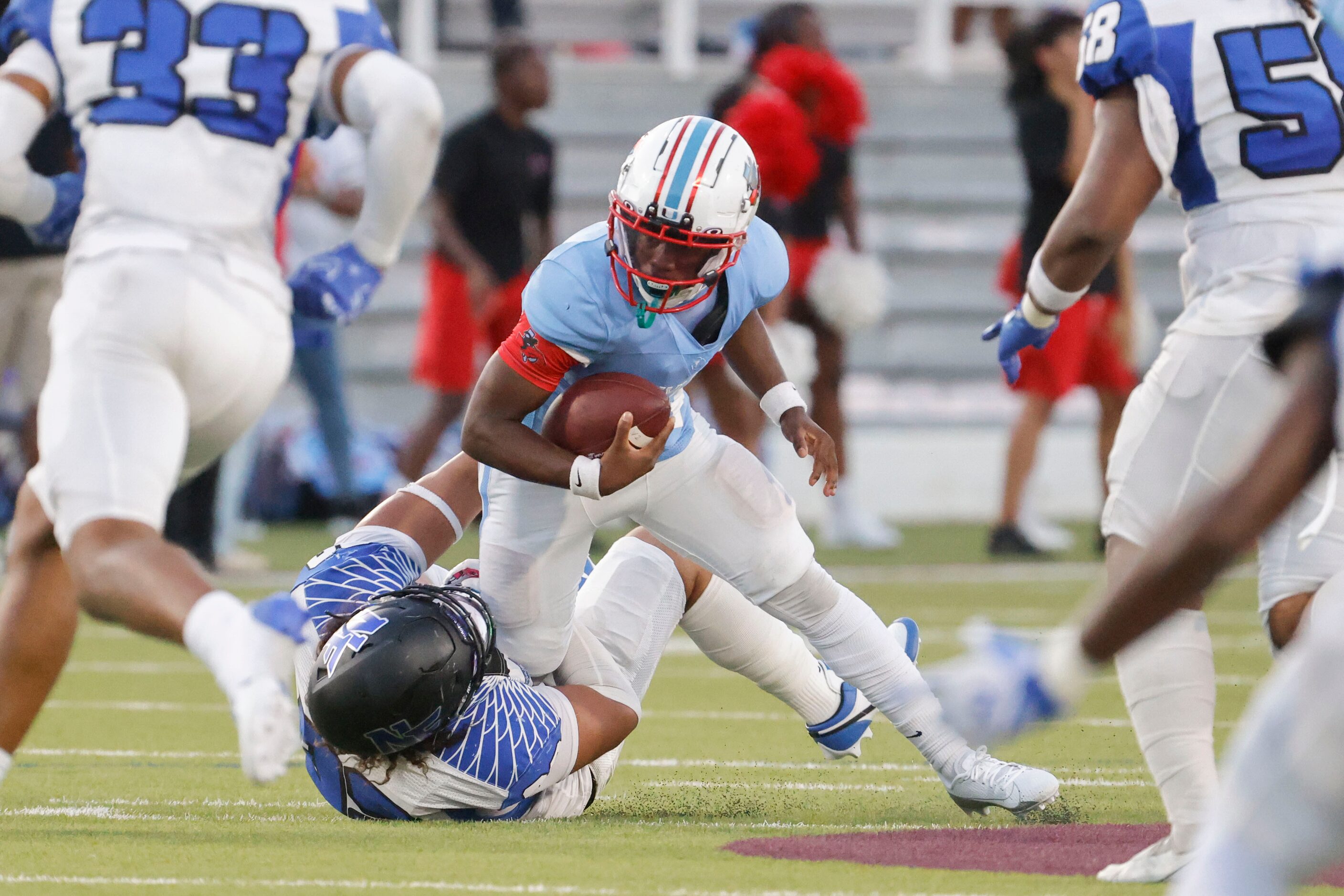 Skyline High’s Donte Ware (center) gets sacked by North Forney High’s Matthew Garcia during...