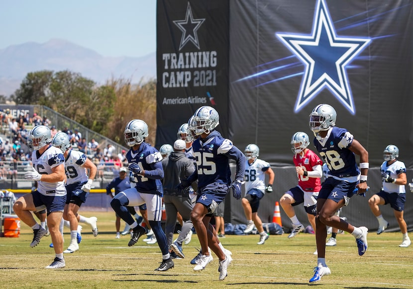 Dallas Cowboys players, including cornerback Israel Mukuamu (38), safety Steven Parker (25)...