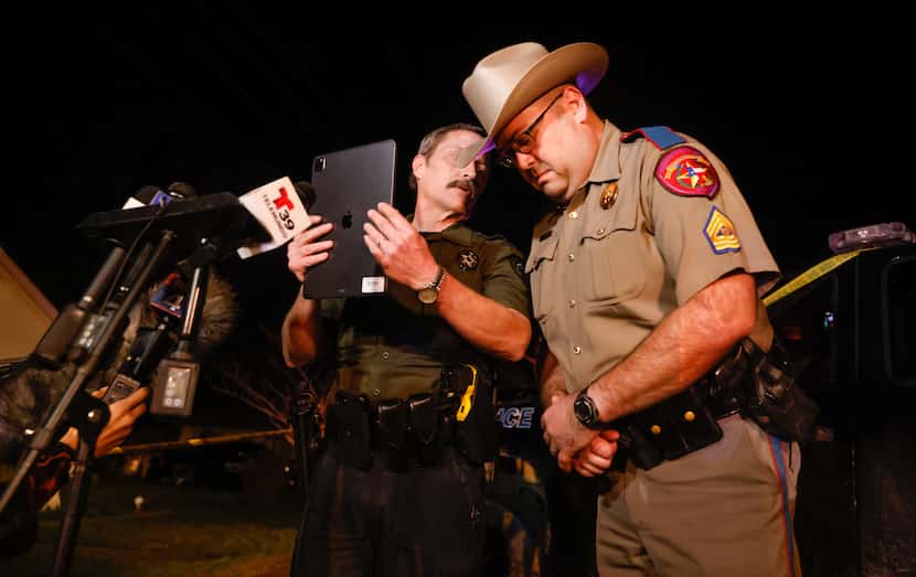 Ellis County Sheriff's Deputy Jerry Cozby (left) spoke with Texas Department of Public...