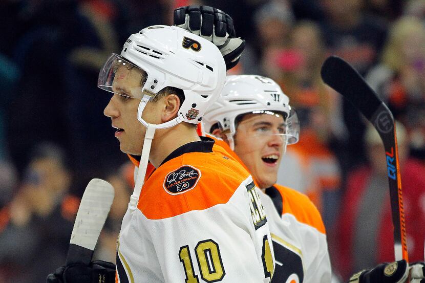 Philadelphia Flyers' Brayden Schenn, who scored three goals for a hat trick, gets a tap on...
