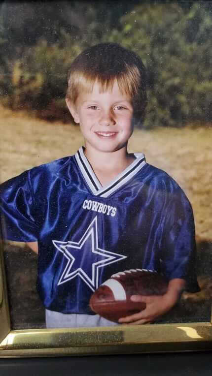 A 5-year-old Brandon Aubrey poses for a photo in his flag football uniform in 2000. The...