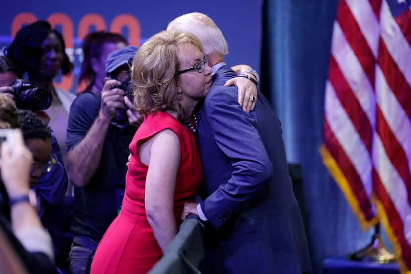 Former vice president and Democratic presidential candidate Joe Biden hugs former Rep. Gabby...