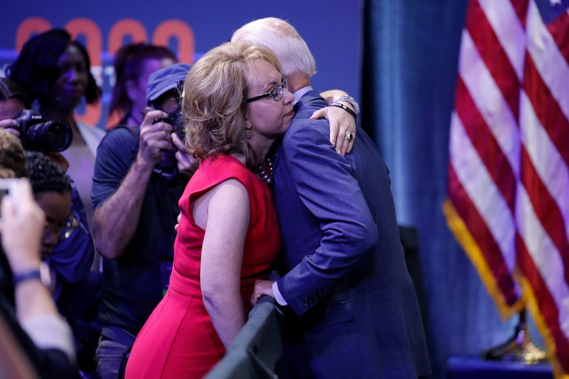 Former vice president and Democratic presidential candidate Joe Biden hugs former Rep. Gabby...