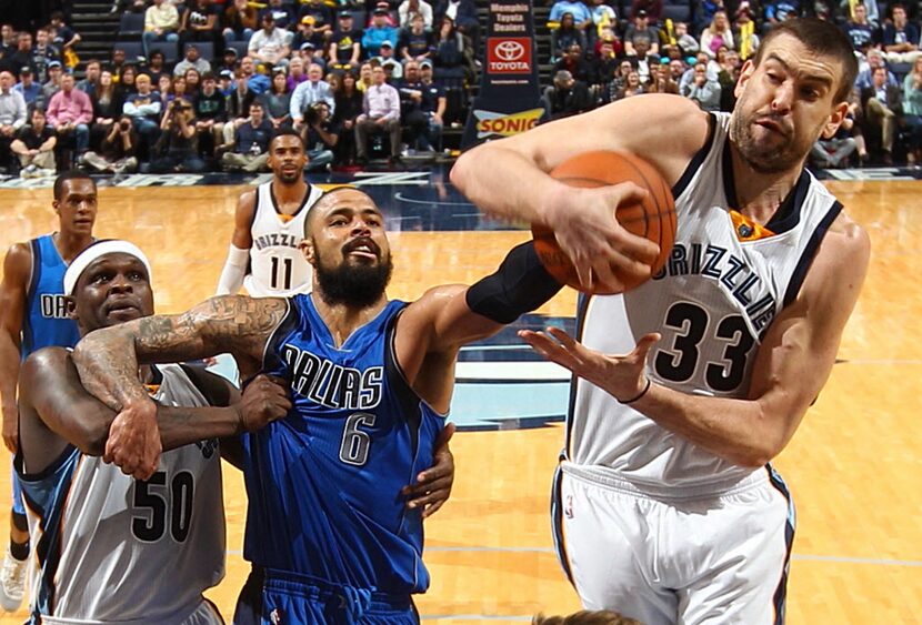 Memphis Grizzlies' Zach Randolph holds back Dallas Mavericks' Tyson Chandler as Marc Gasol...