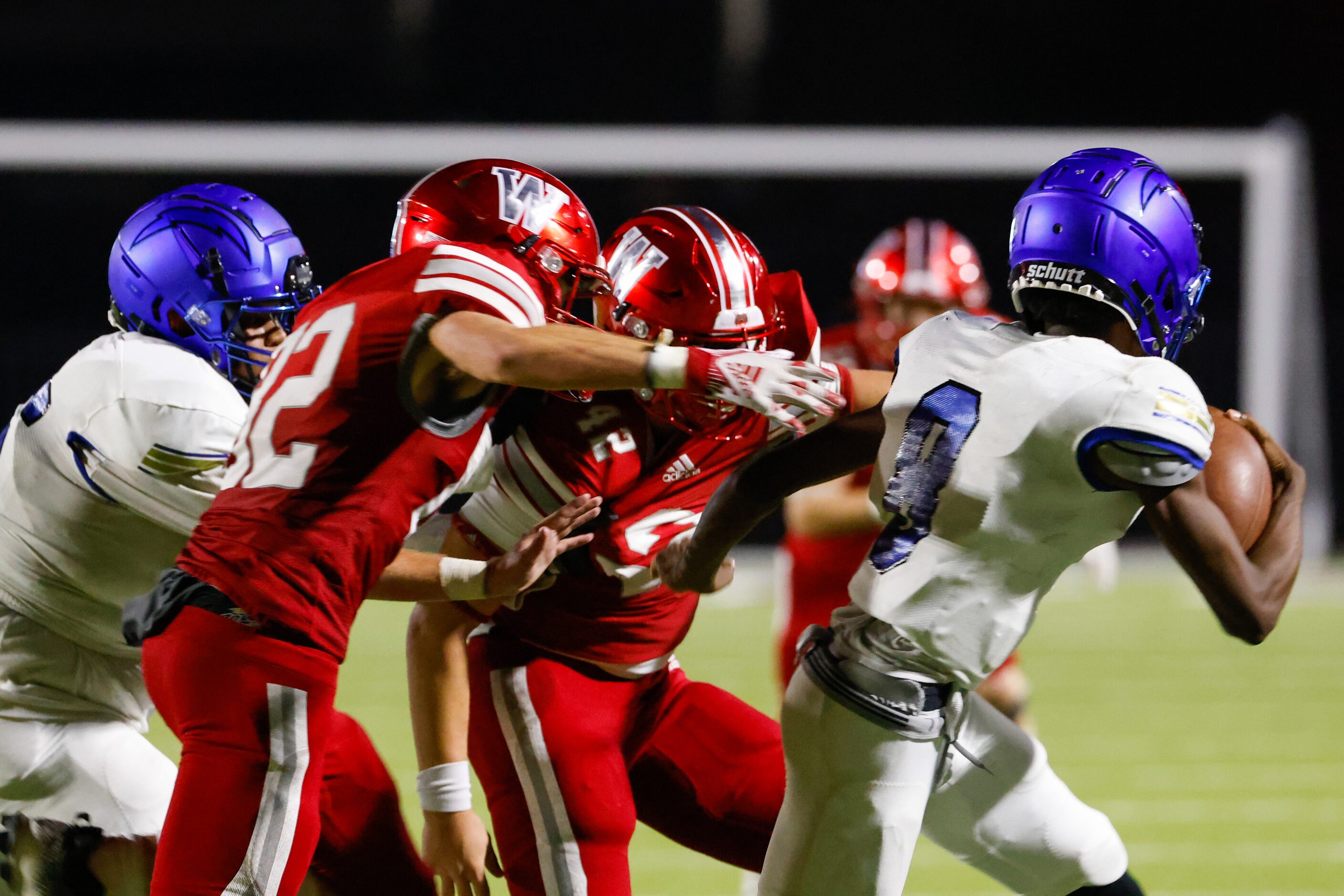 Conrad quarterback Ladavian Frost-Harris (8) runs toward the sidelines while being chased by...