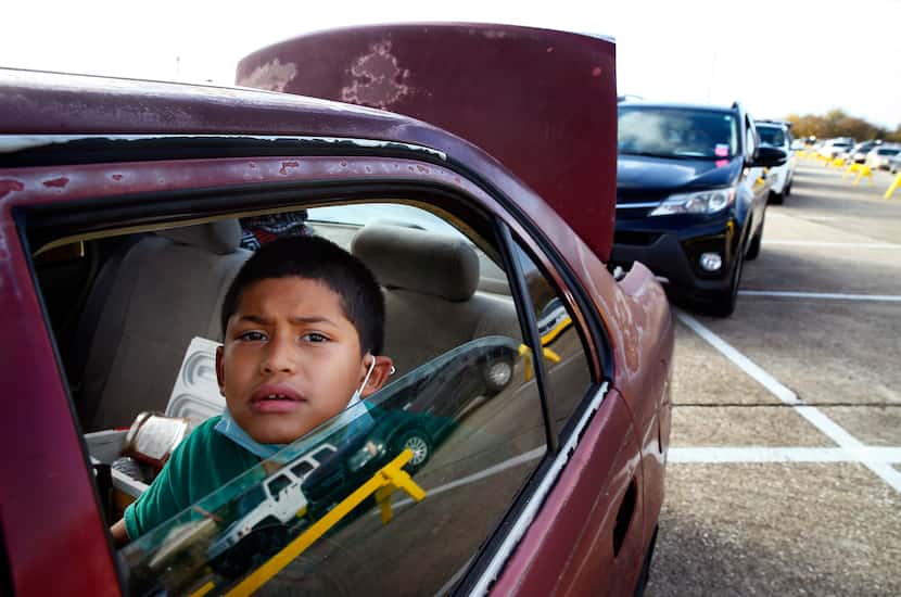 Ivan Gonzalez, 7, waited overnight with his stepfather in their car to get food.