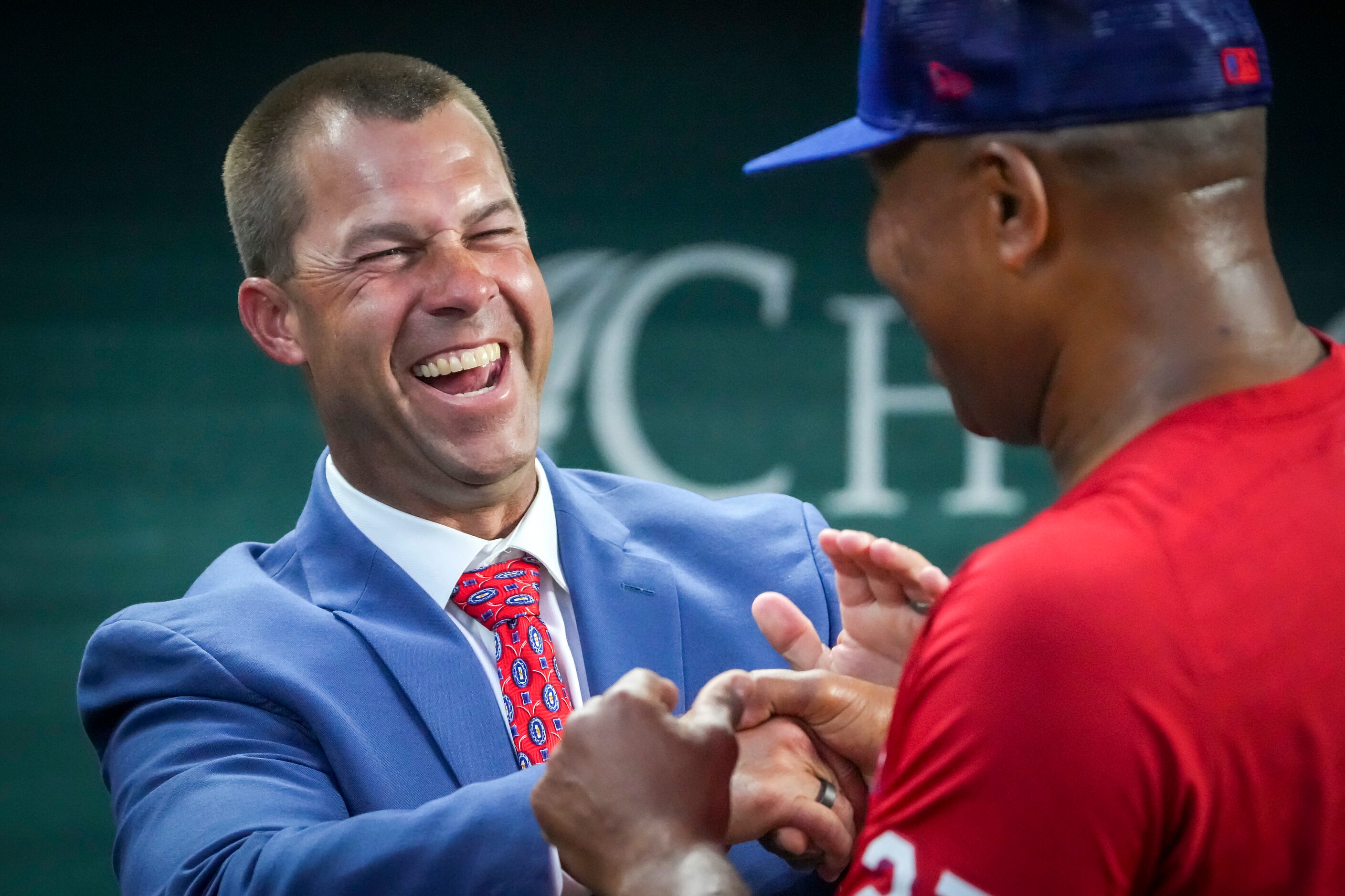 Texas Rangers director of player development Josh Bonifay laughs with third base coach Tony...