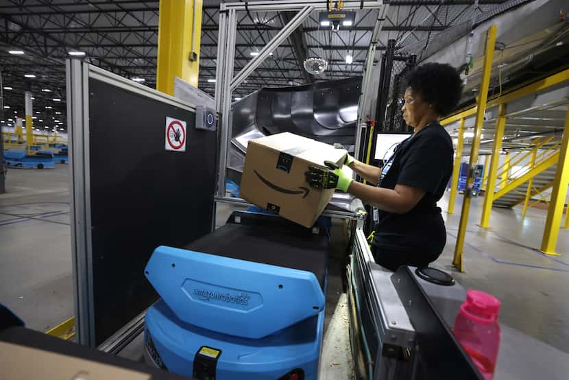 Sonja Williams loads a "P-Drive" unit with a package at the Amazon North Texas Air Hub in...
