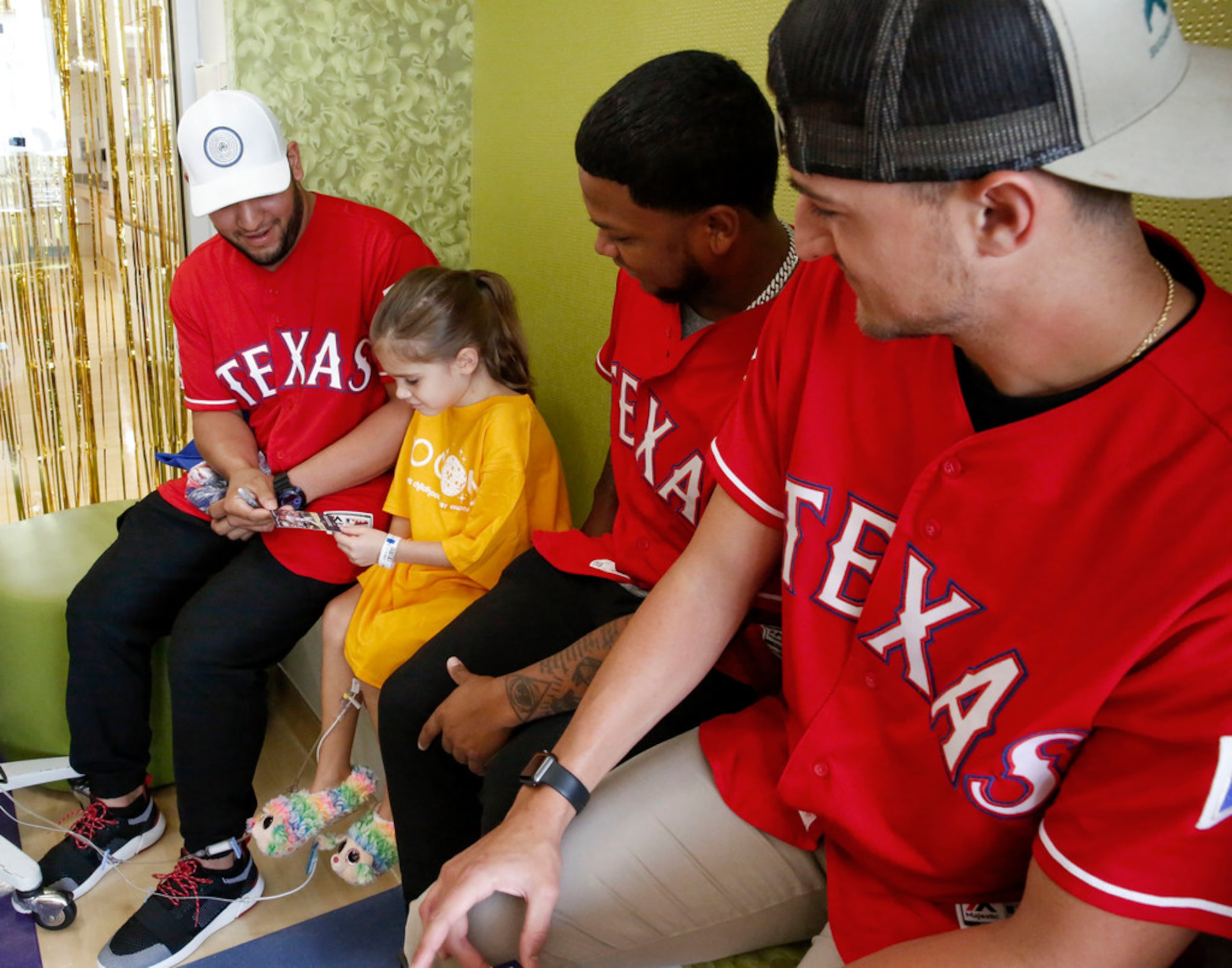 Texas Rangers catcher Jose Trevino, left  outfielder Willie Calhoun and pitcher Brett Martin...