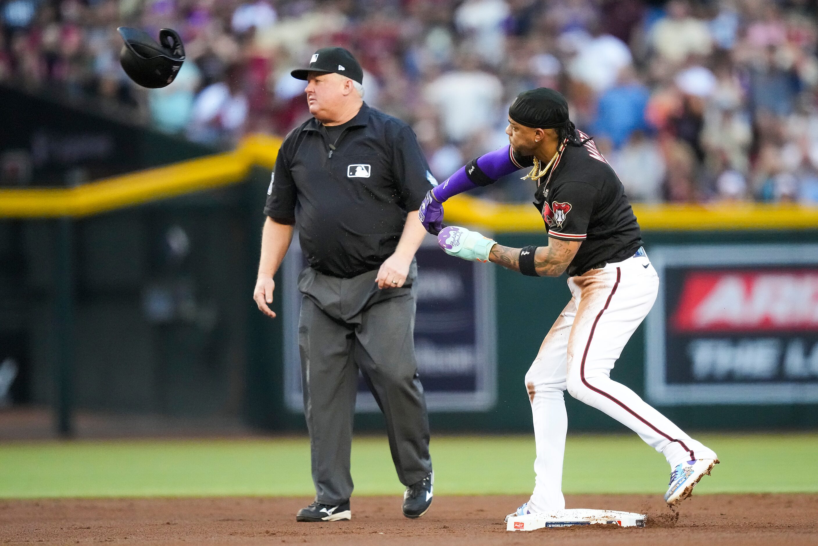 Arizona Diamondbacks second baseman Ketel Marte tosses his helmet after being caught...