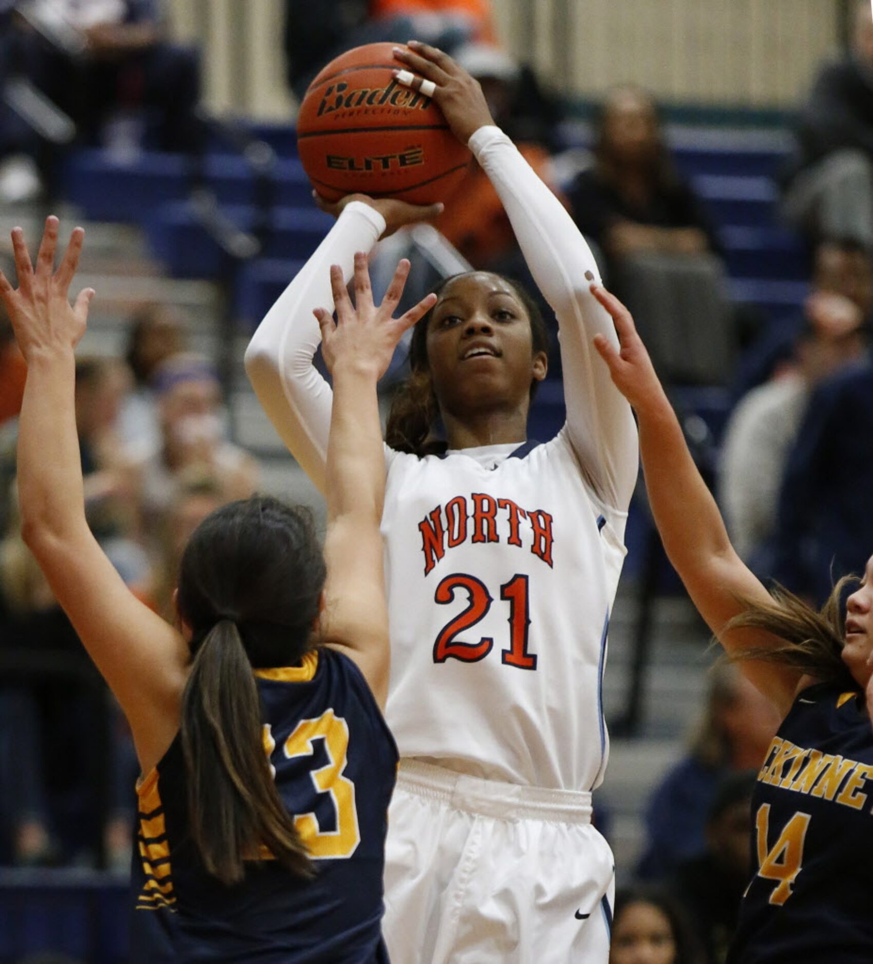 McKinney North's Chanterria Jackson (21) takes a shot for two points in front of McKinney's...