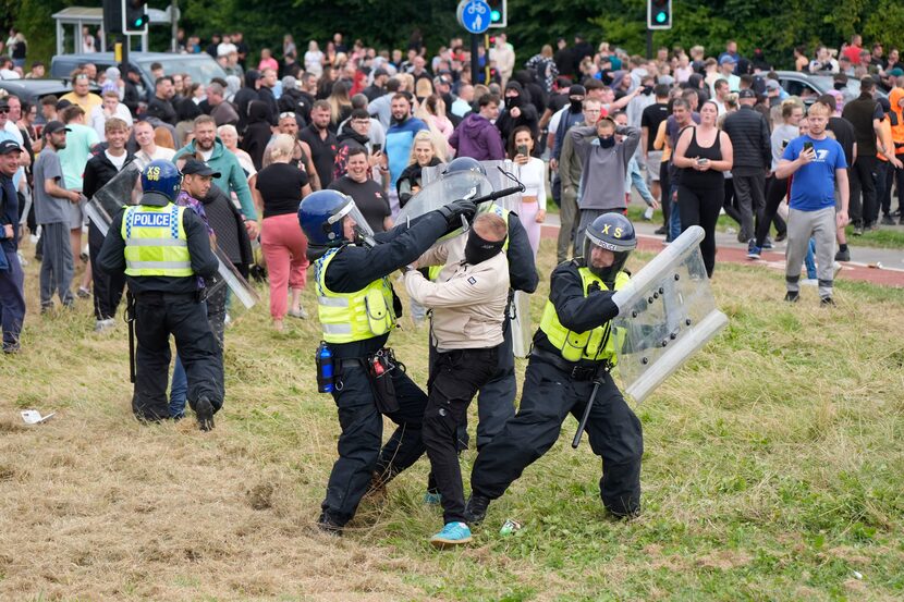 Police grappled with a man during the  anti-immigration protest outside the Holiday Inn...