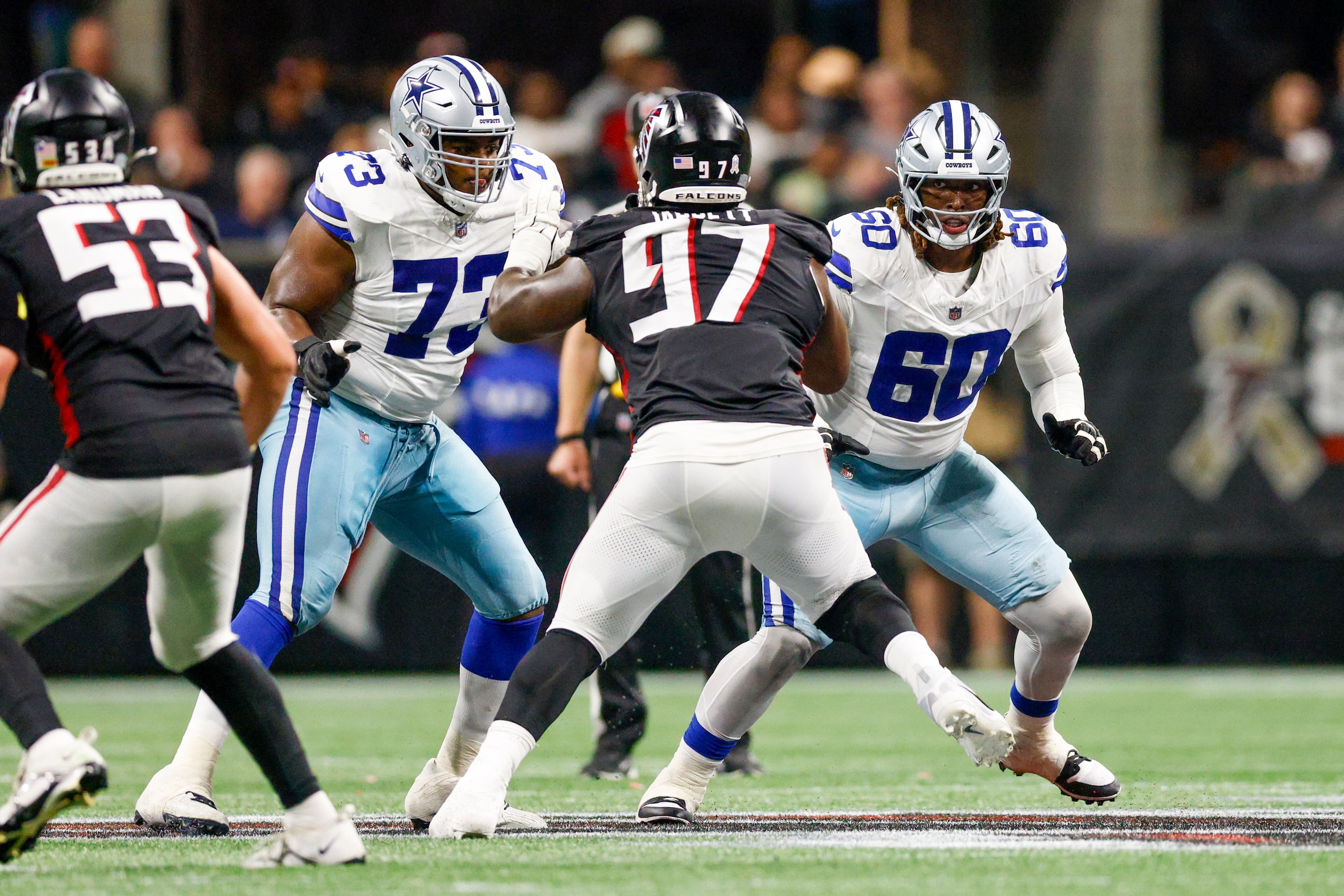 Dallas Cowboys offensive tackle Tyler Smith (73) and offensive tackle Tyler Guyton (60) drop...