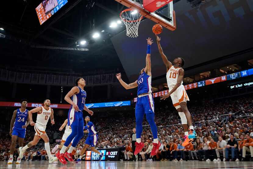 Texas guard Sir'Jabari Rice, right, drives to the basket against Kansas forward Jalen...