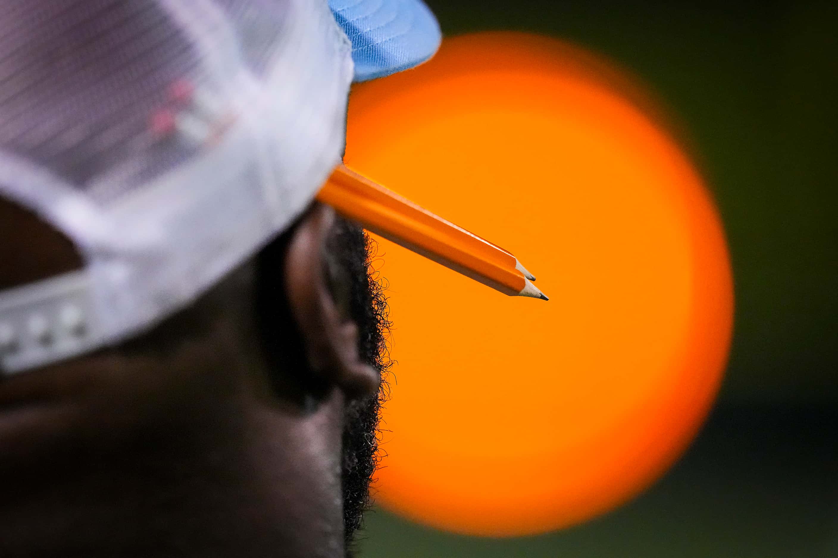 A Wylie East coach keeps two sharpened pencils at the ready tucked into his hat during the...