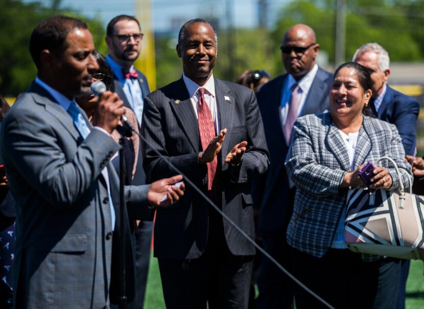 U.S. Secretary of Housing and Urban Development Ben Carson (center) applauds as Troy...