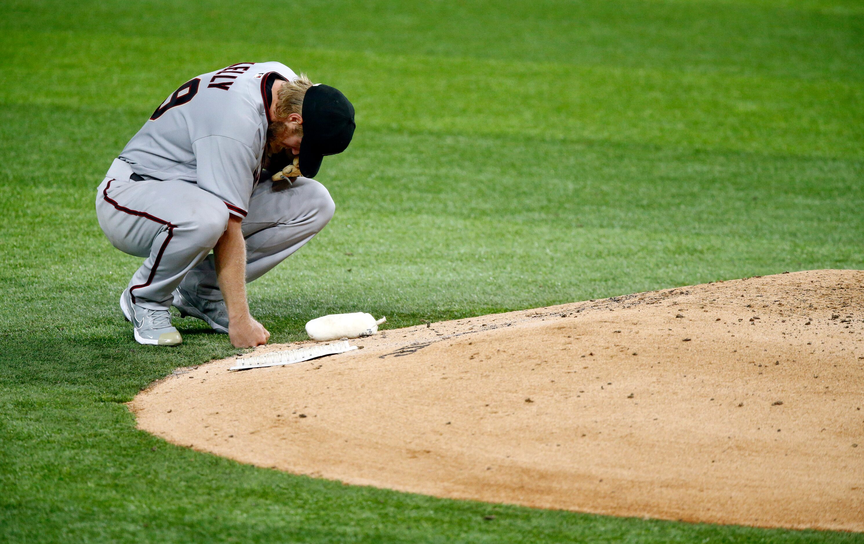 Arizona Diamondbacks starting pitcher Merrill Kelly (29) takes a moment behind the mound...