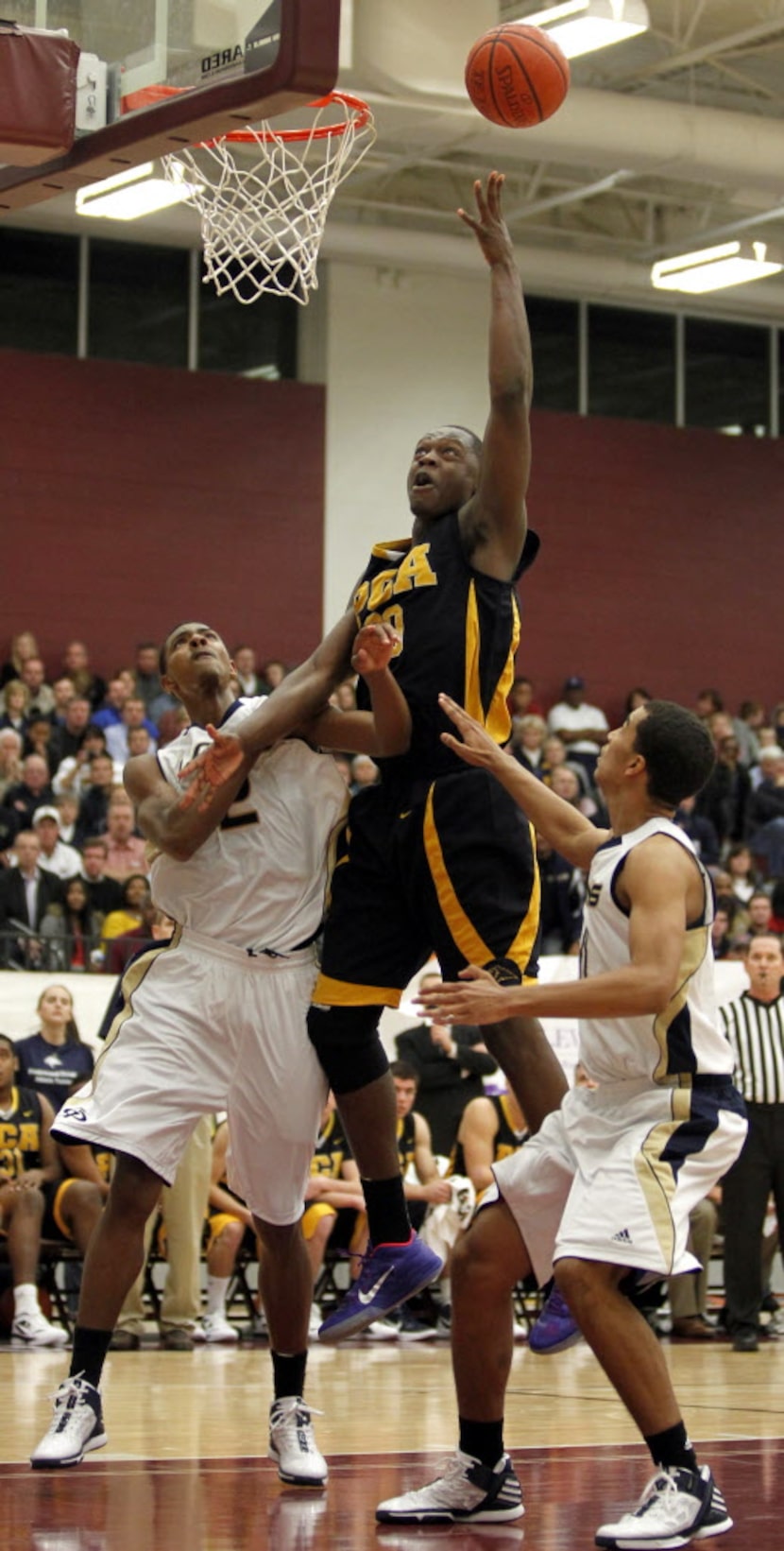 Grace Prep's Jordan Mickey (2) and Micah Seaborn (11) try to keep Prestonwood Christian's...