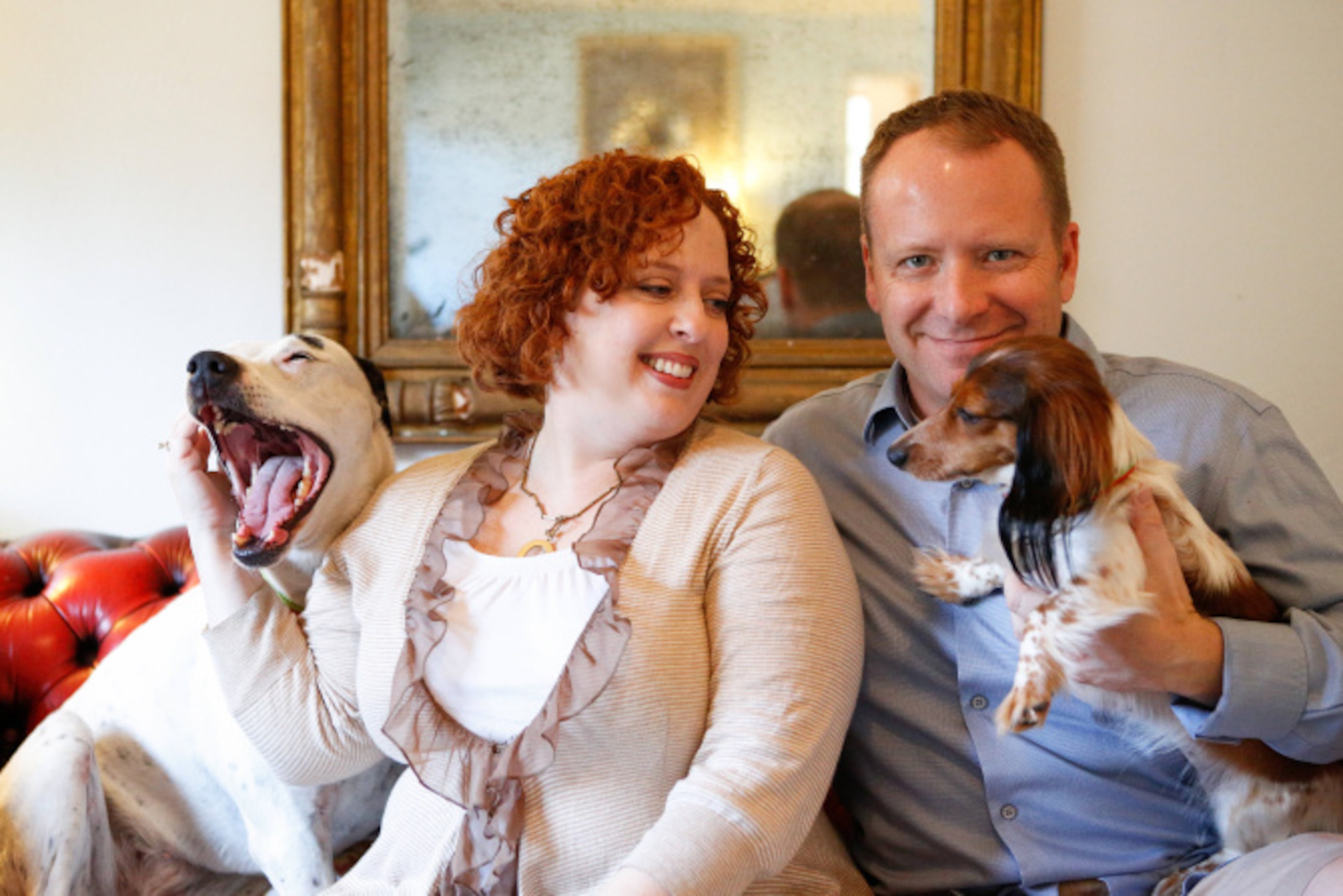 Lisa and Jason Druebert sit for a portrait with their dogs Pup, left, and Schnitzel in their...