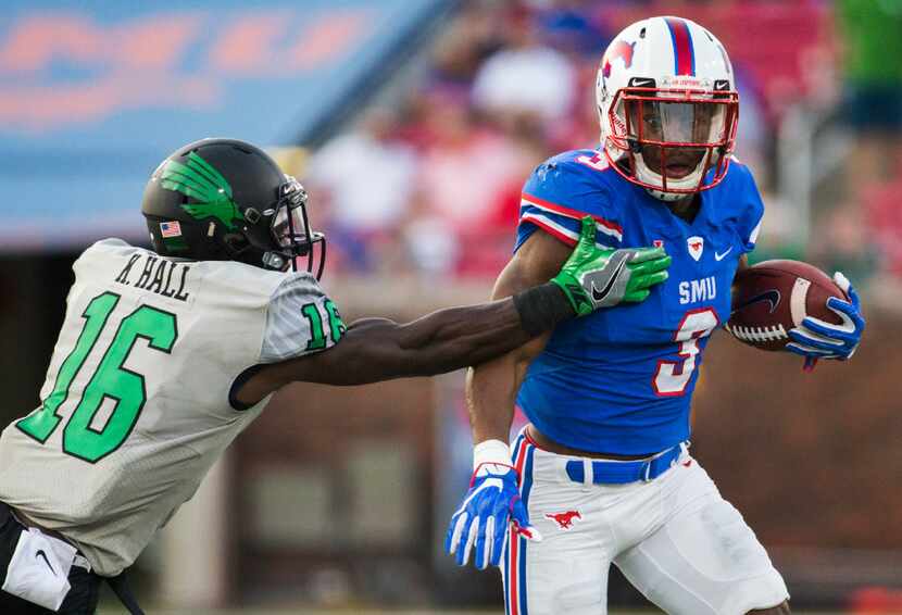 North Texas Mean Green defensive back Kemon Hall (16) tackles Southern Methodist Mustangs...