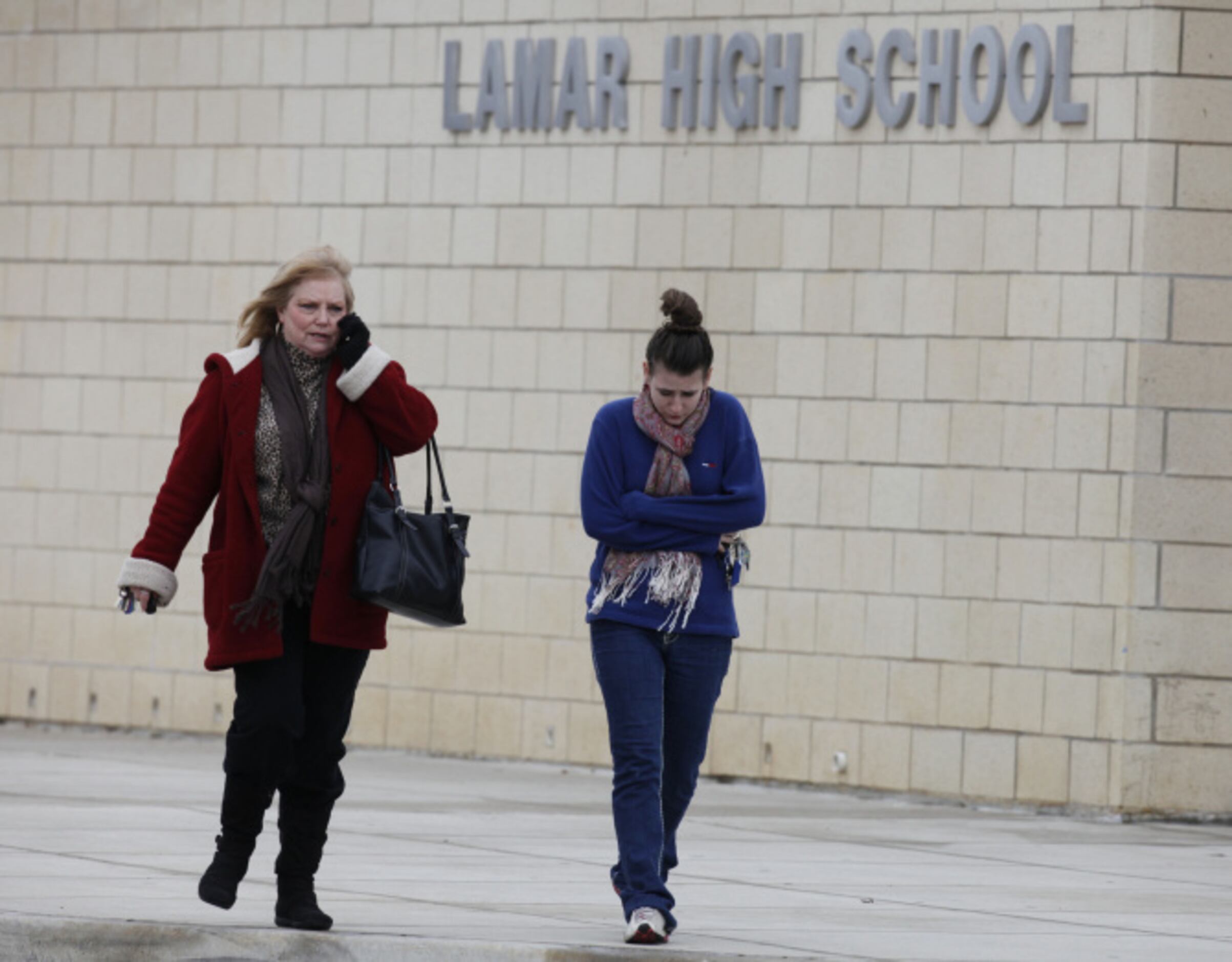 Serena Craker, left, walks out of Lamar High School with student Shelby Paul,  after a...