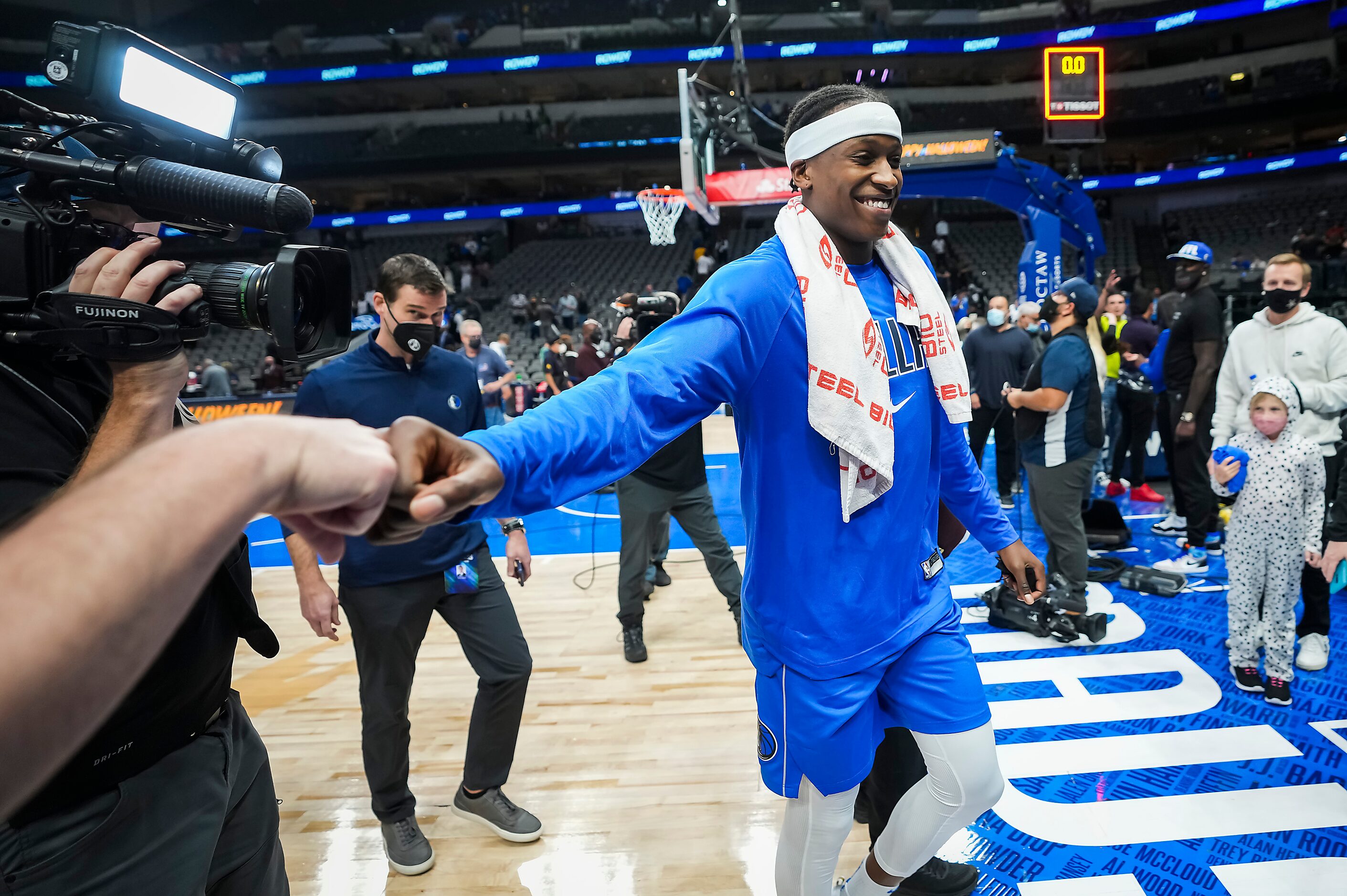 Dallas Mavericks guard Frank Ntilikina reaches out to fans as he leaves the court after a...