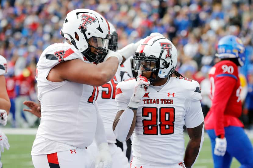 Texas Tech running back Tahj Brooks (28) celebrates with offensive lineman Caleb Rogers,...