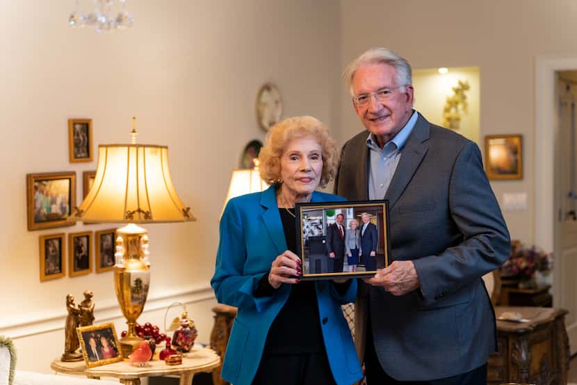 Residents of Edgemere Senior Living holding a photo of their sons