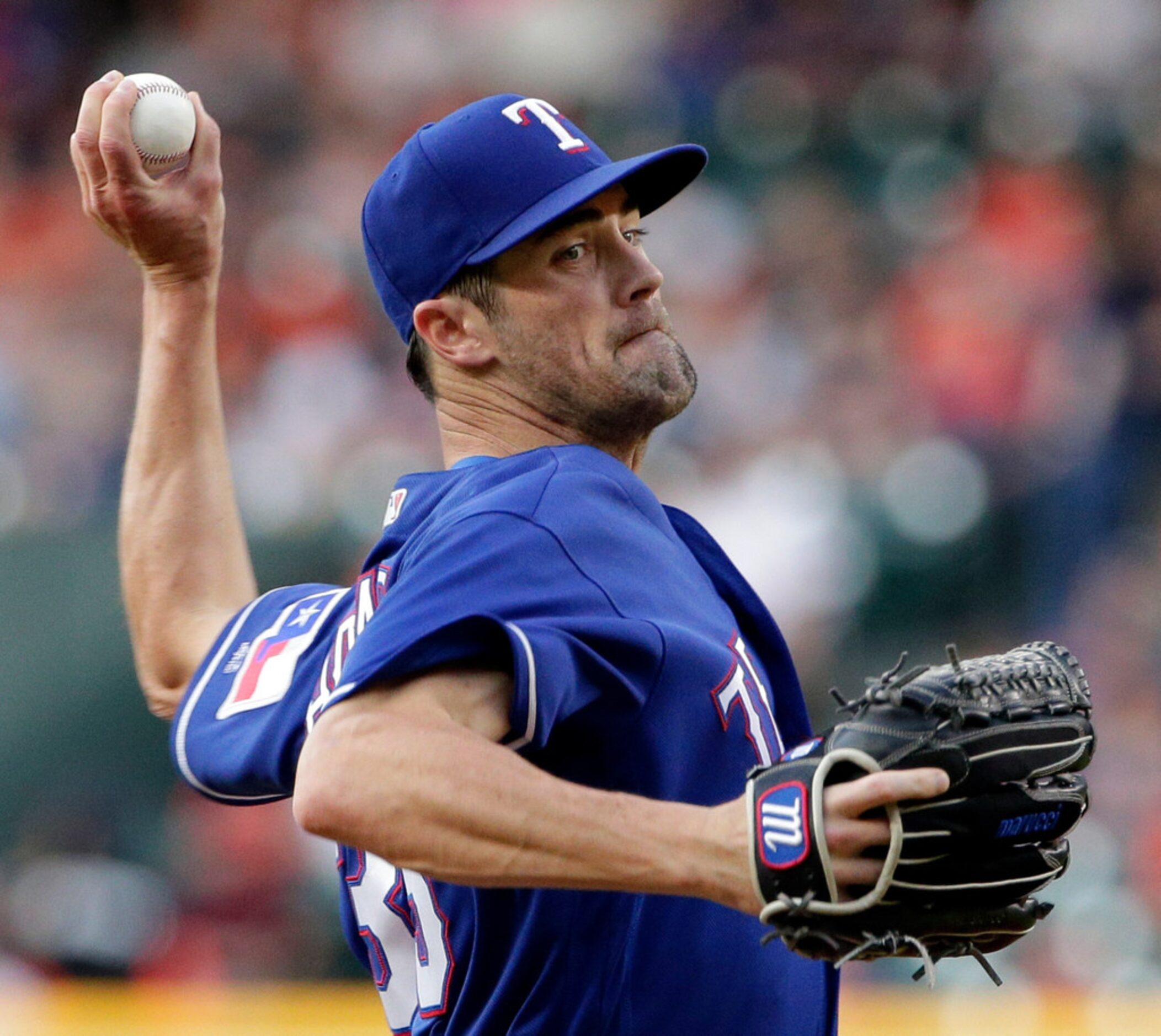 Texas Rangers starting pitcher Cole Hamels throws to a Houston Astros batter during the...