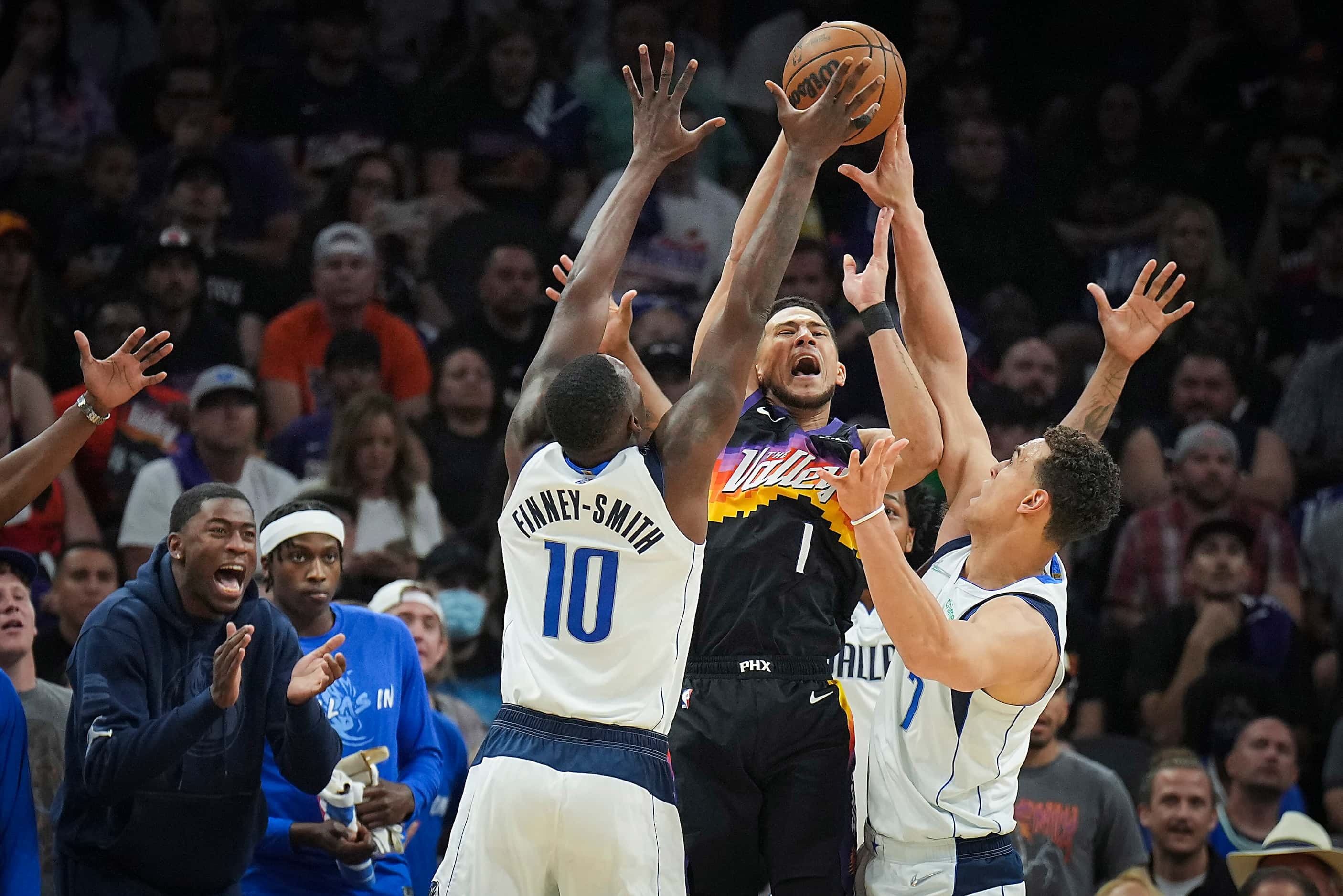 Phoenix Suns guard Devin Booker (1) is defended by Dallas Mavericks forward Dorian...