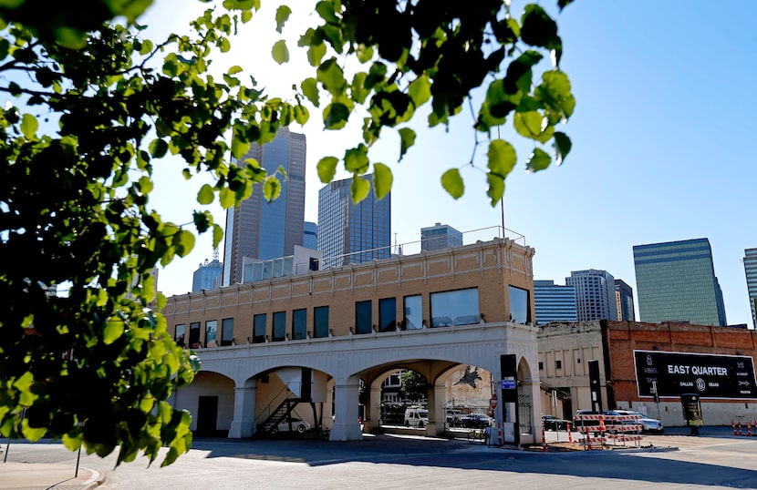 The original Magnolia Oil building (left), and a sign promoting the East Quarter...