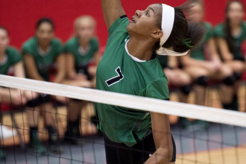Southlake Carroll sophomore middle blocker Asjia O'Neal goes up for a hit against Allen...