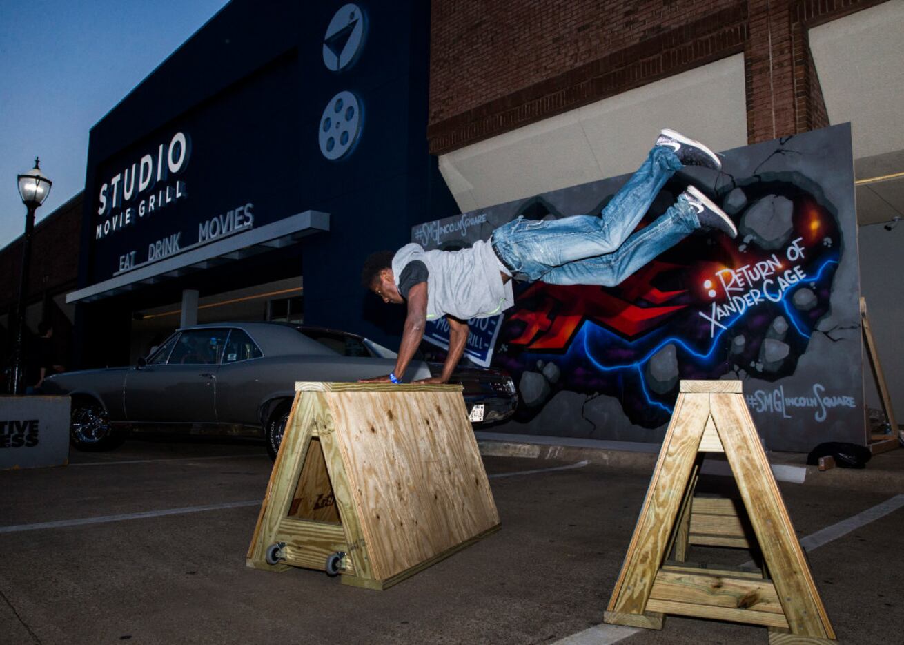 Parkour performer Terry White jumps over hurdles as Studio Movie Grill opens it's 24th and...