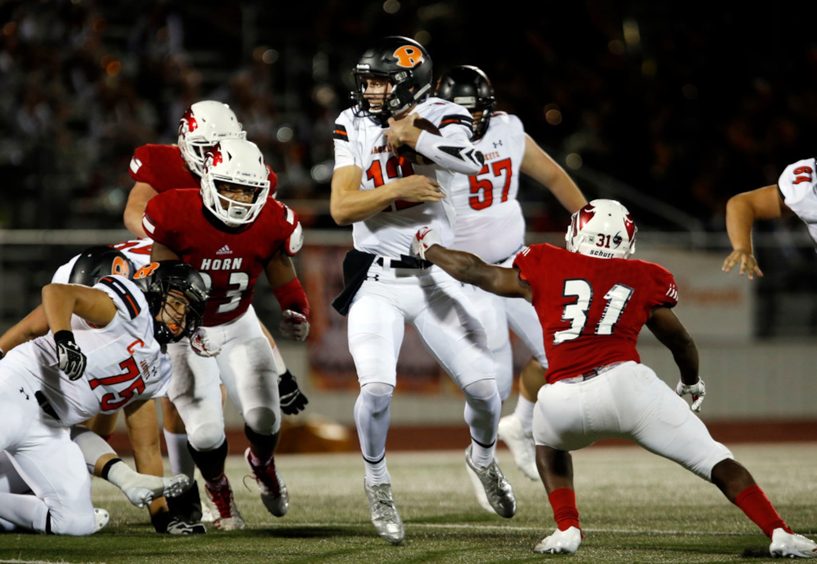 The Mesquite Horn defense, including David Fasanya (31) swarms around Rockwall QB Jacob...