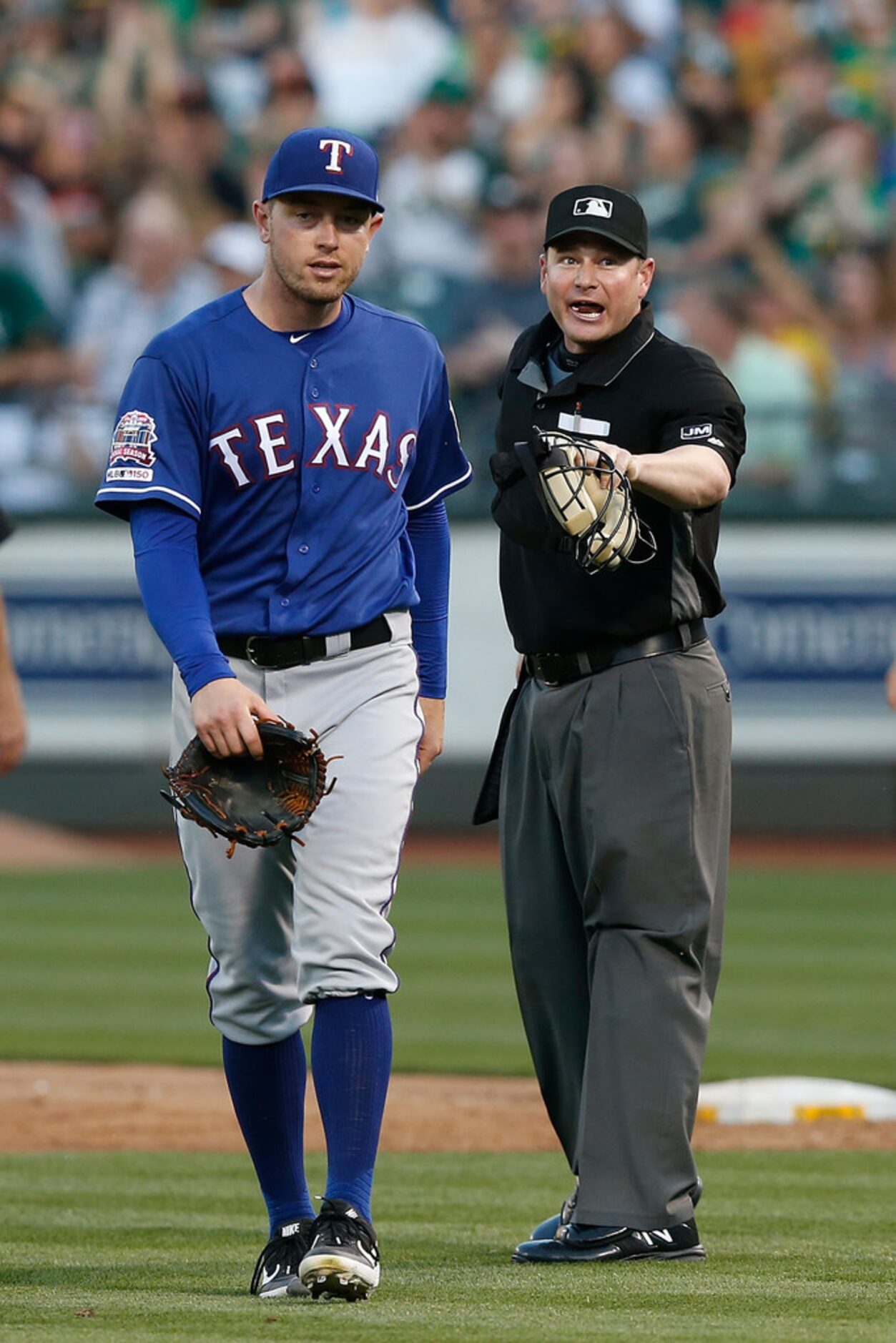 OAKLAND, CALIFORNIA - JULY 27: Umpire Sean Barber #29 talks to pitcher Adrian Sampson #52 of...