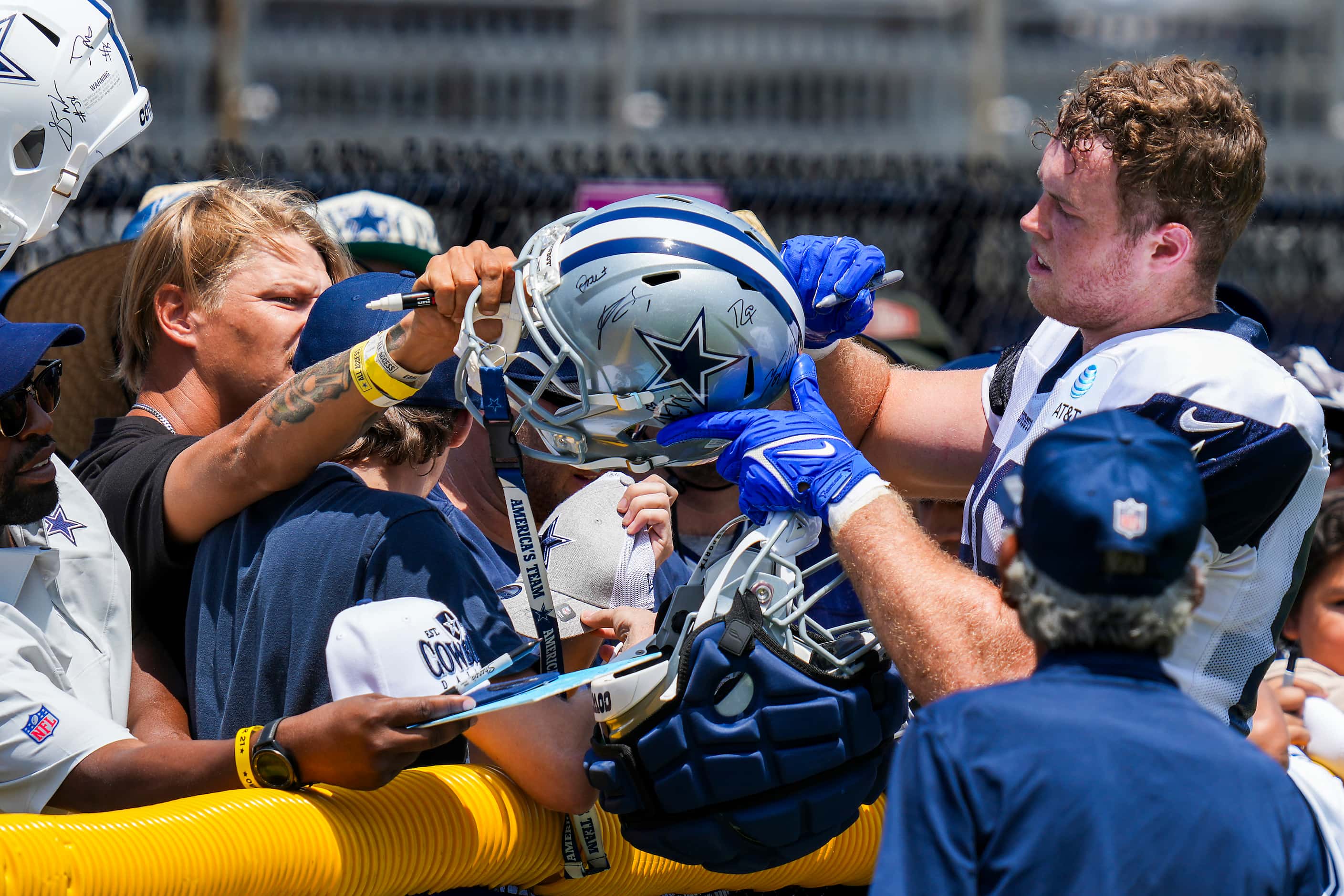 Dallas Cowboys tight end Luke Schoonmaker  signs autographs for fans following a training...
