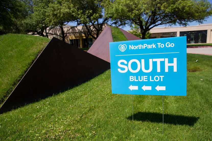 NorthPark To Go signs direct customers to the blue lot for order pickups per Texas Gov. Greg...