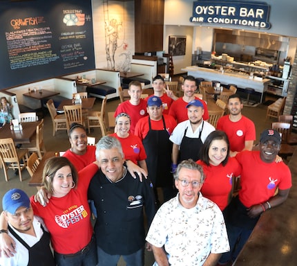 Bill Bayne of Fish City Grill poses with the crew of the restaurant located at 1415 East...