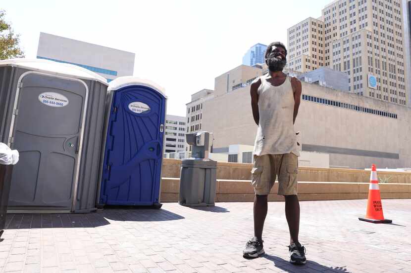 Willie Seals stands near port-a-potties that he and others use in downtown Dallas outside of...