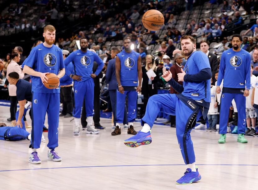 Dallas Mavericks guard Luka Doncic (77) kicks the basketball soccer style as the team warms...