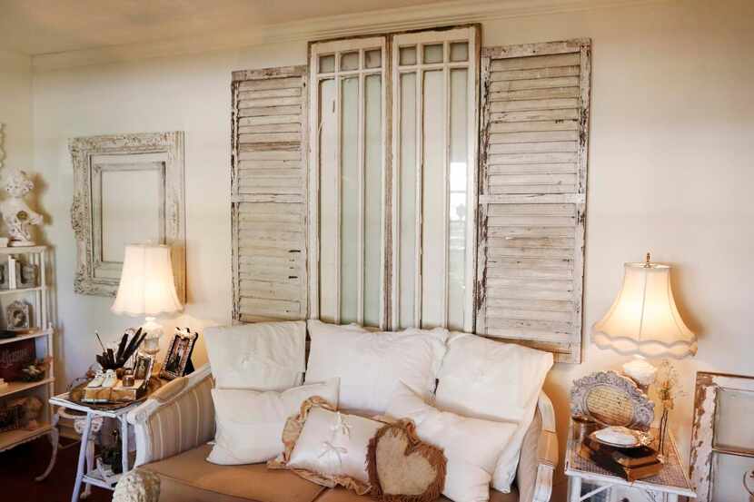 
Young uses old shutters and a window frame to bring comforting sturdiness to a bare wall.

