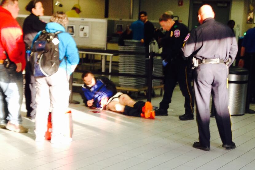 Brent James Taff, who attempted to escape custody, lies on the floor after being shot at DFW...