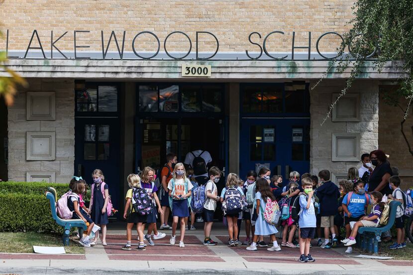 Children gather outside during dismissal time at Lakewood Elementary School, home to Dallas...