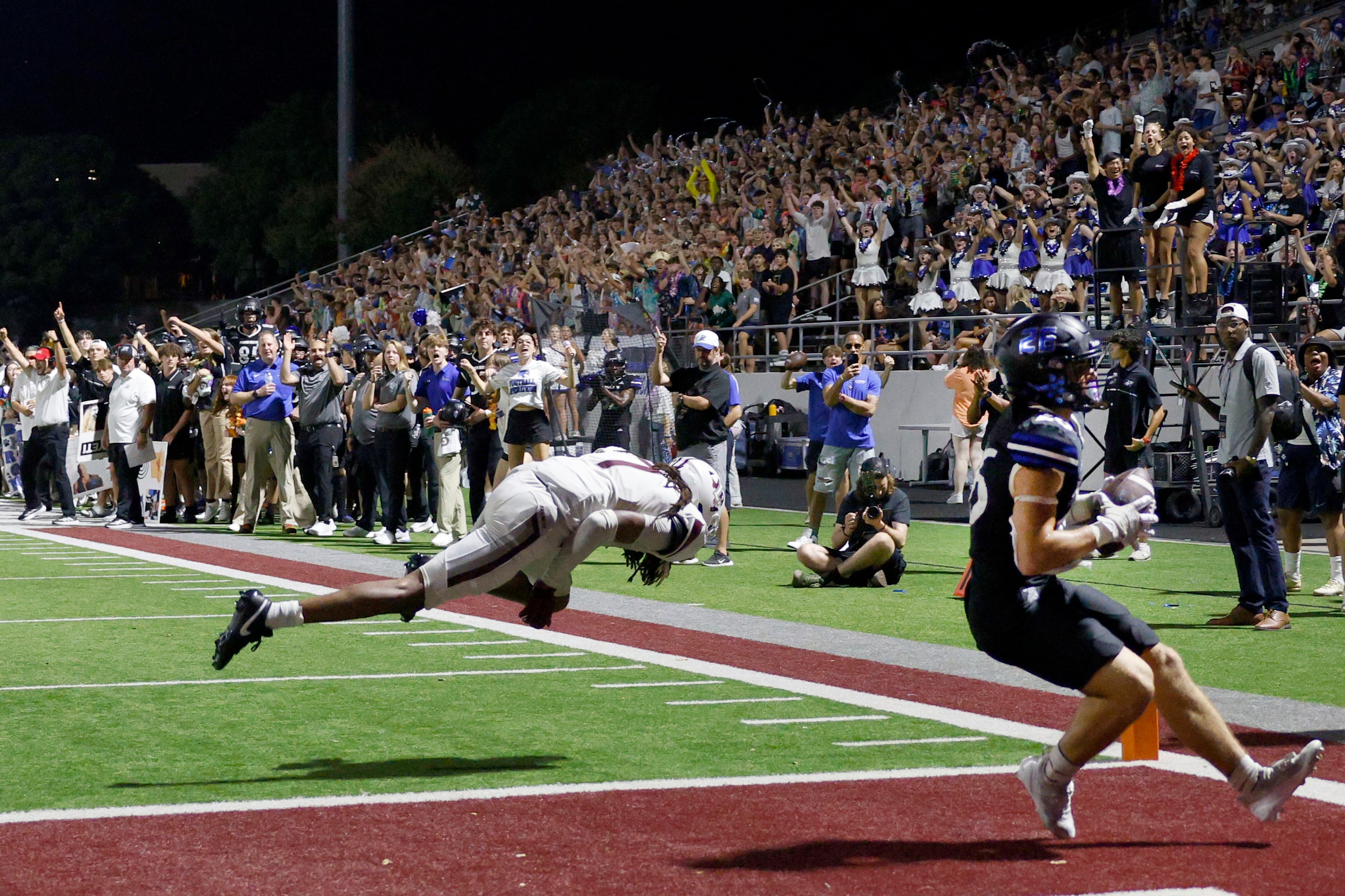 Byron Nelson's Tucker James (26) scores a touchdown over Lewisville's Taelyn Mayo (7) during...